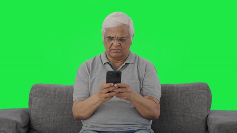 Indian-old-man-chatting-on-phone-Green-screen