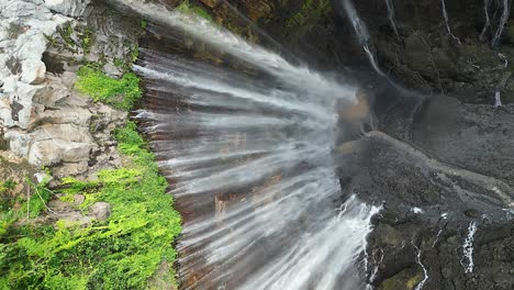 vertical format: stunning tumpak sewu waterfall in tall java canyon