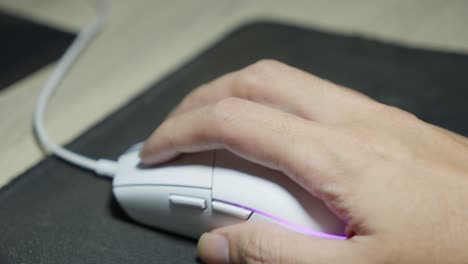 hand gestures of wired computer mouse user, device movement on desk mousepad