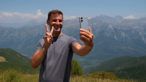man taking selfie with mountain view