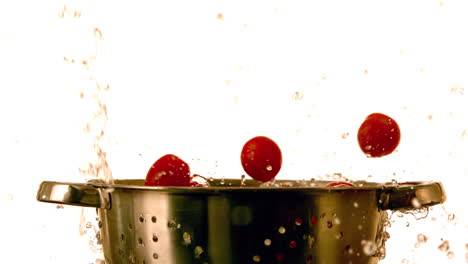 cherry tomatoes and water falling into colander