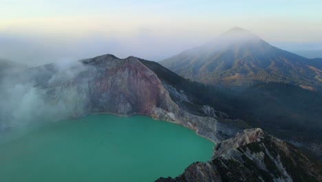 drone shot of ijen green acid lake with a impressive mountain at the back ground in java indonesia