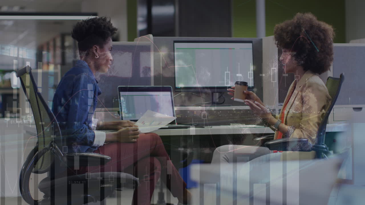 Animation of multiple graphs over diverse female coworkers discussing reports on computer