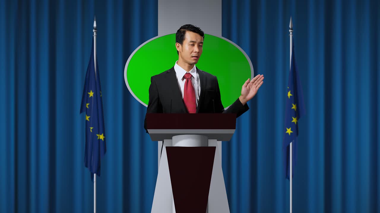 Asian Portrait Of Organization Representative Speaking At A Press Conference In Government Building With Mock Up Green Screen, Press Officer Delivering A Speech At A Summit. Backdrop With Eu Flags