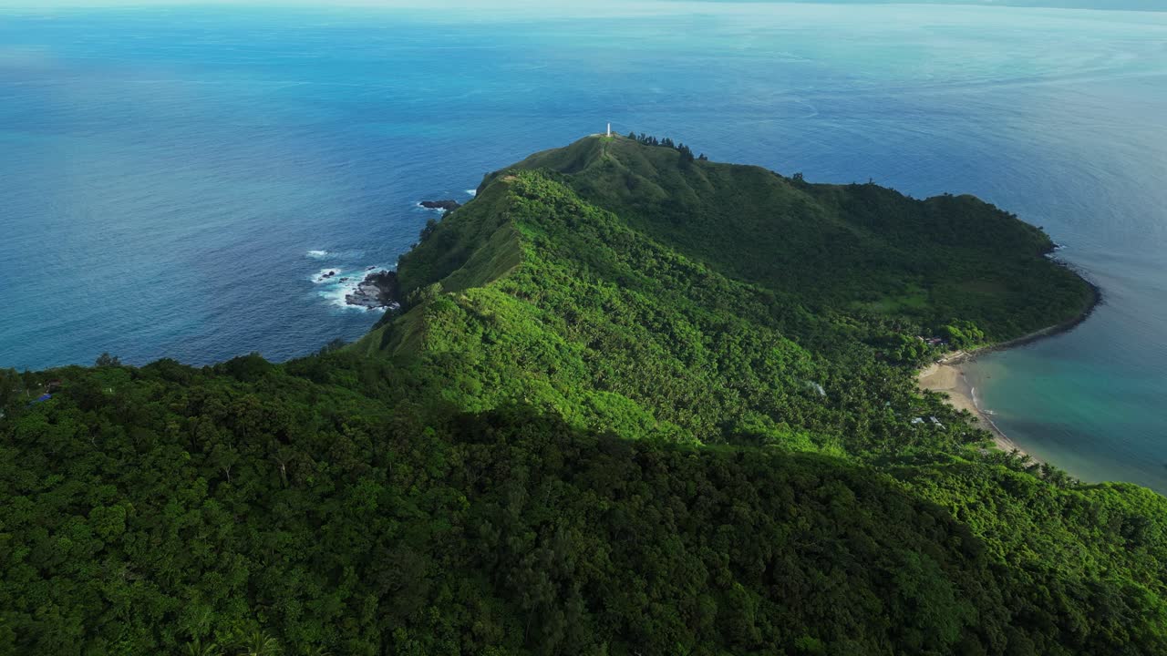 Forward aerial of Dingalan mountain view in Aurora, gliding above lush green ridges and winding slopes that descend toward the rugged coastline and deep blue sea
