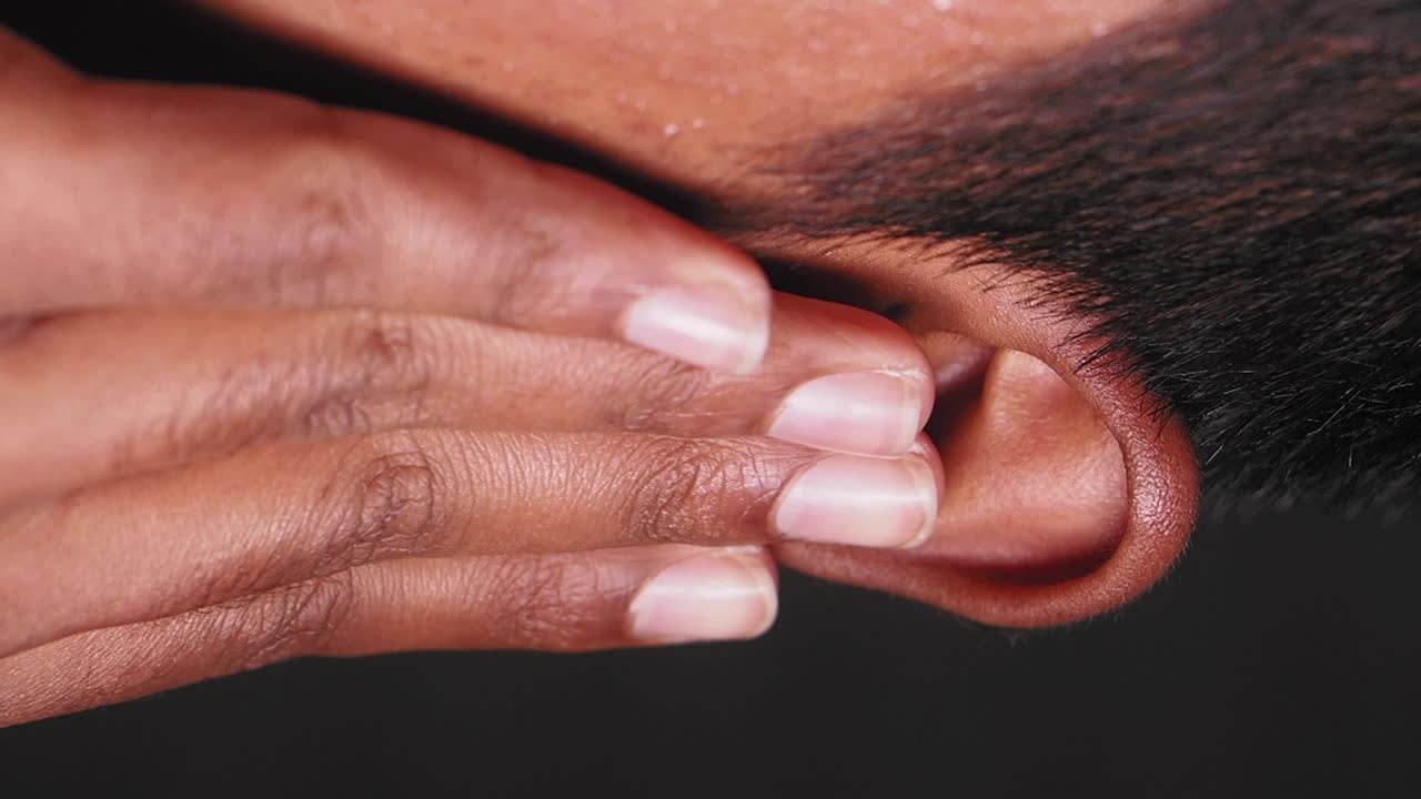 Man touching his ear in pain