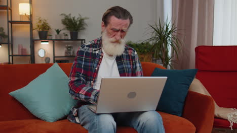 tired senior man freelancer use laptop suffering from headache problem tension and migraine, stress