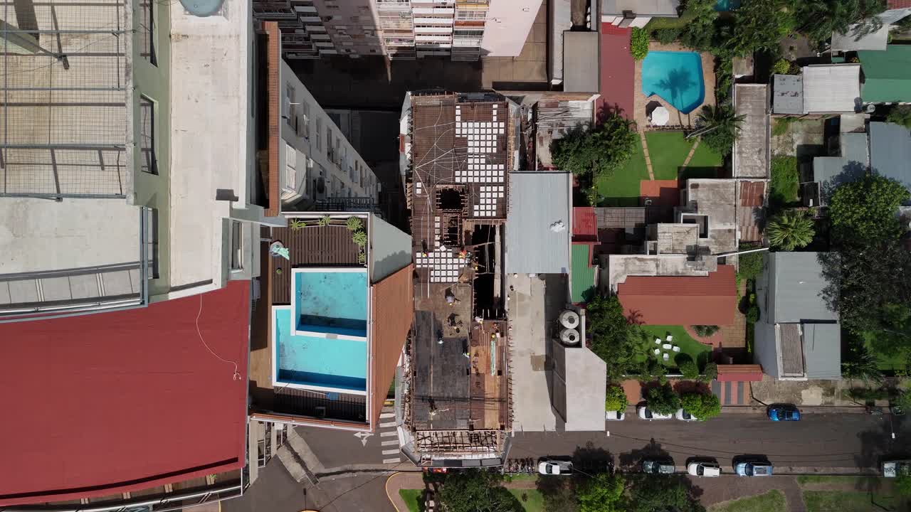 vista cenital que captura el atractivo de los edificios residenciales con piscinas en la azotea, armonizando el lujo y la vida moderna en un oasis urbano exclusivo