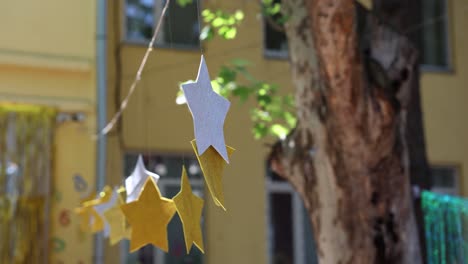 hanging star decorations made of silver and gold