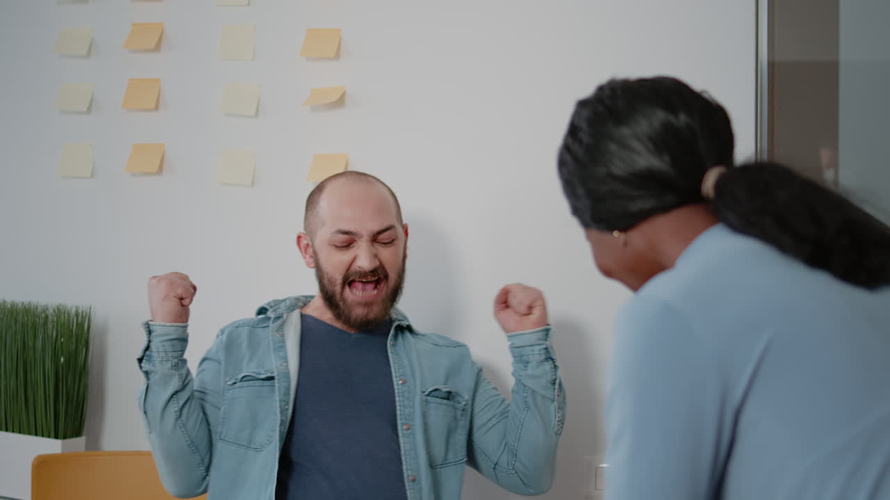 Man winning game at foosball table to do fun activity after work