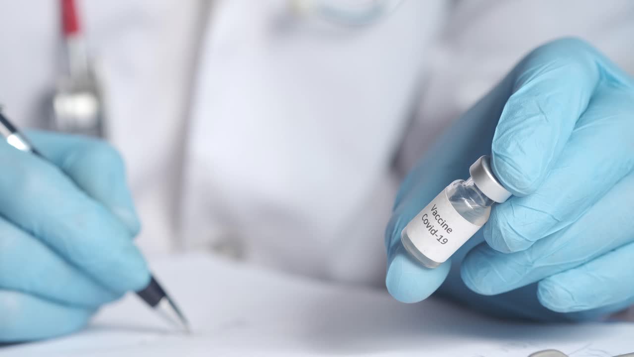 Doctor holding a COVID-19 vaccine vial