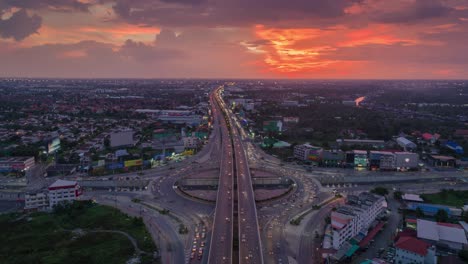 time-lapse or hyper-lapse aerial view 4 way road stop circle highway or intersection traffic with beautiful sky for transportation concept.