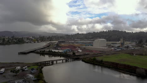 drone flying towards georgia-pacific west wood manufacturing company in coos bay, oregon