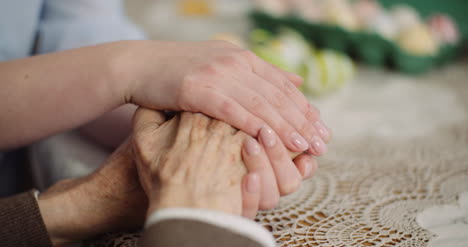 woman comforting wrinkled old hand 6