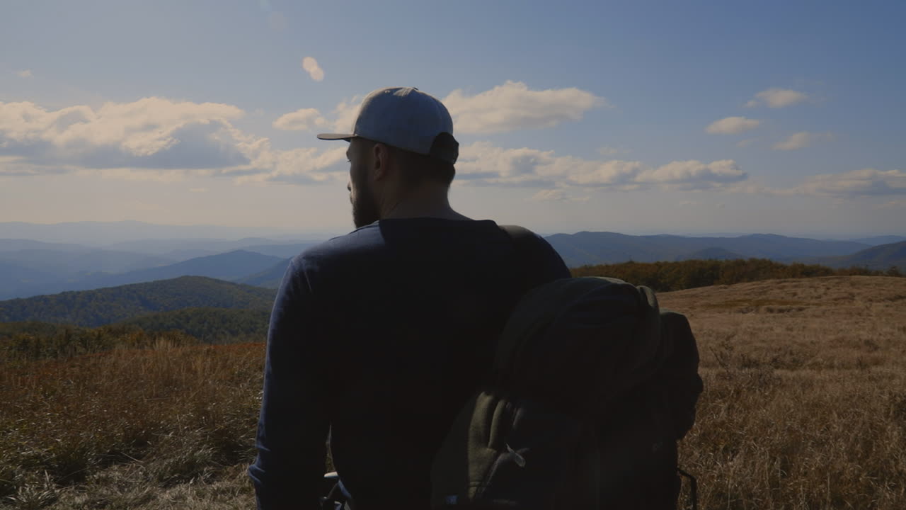Backpacker and his dog at the top of the hill