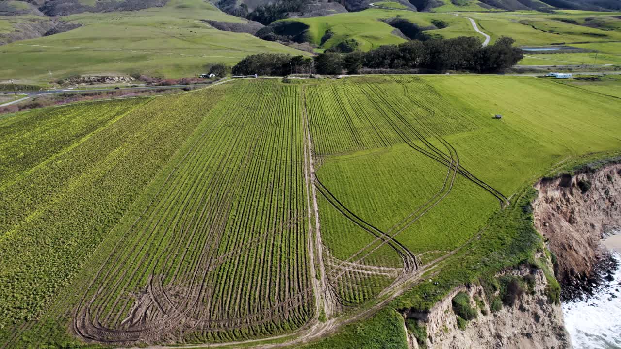 Aerial Drone View of a Car Driving Through Vast California Farmland on a Rural Road