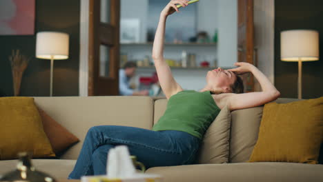 Artistic woman speaking phone video call at home. Lady gesticulates theatrically
