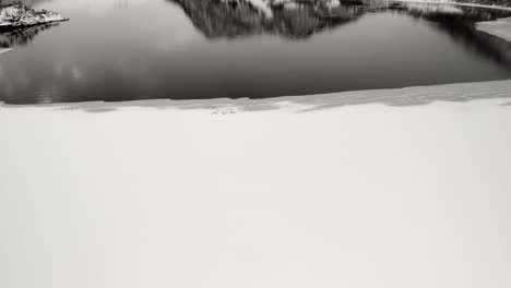 Drone-shot-of-snowy-Mountains-in-Tromso,-Norway-during-winter