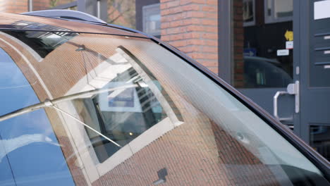 a  caucasian lady getting out of the car and going into a building