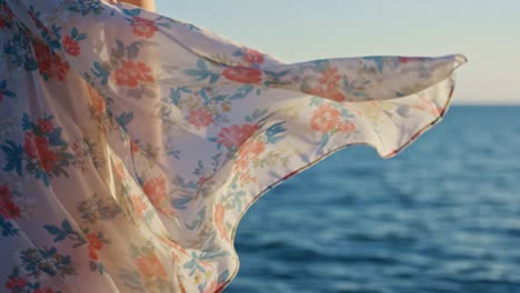 a serene moment by the water: flowing floral fabric dancing in the breeze against a calm ocean backdrop, capturing nature's beauty and tranquility