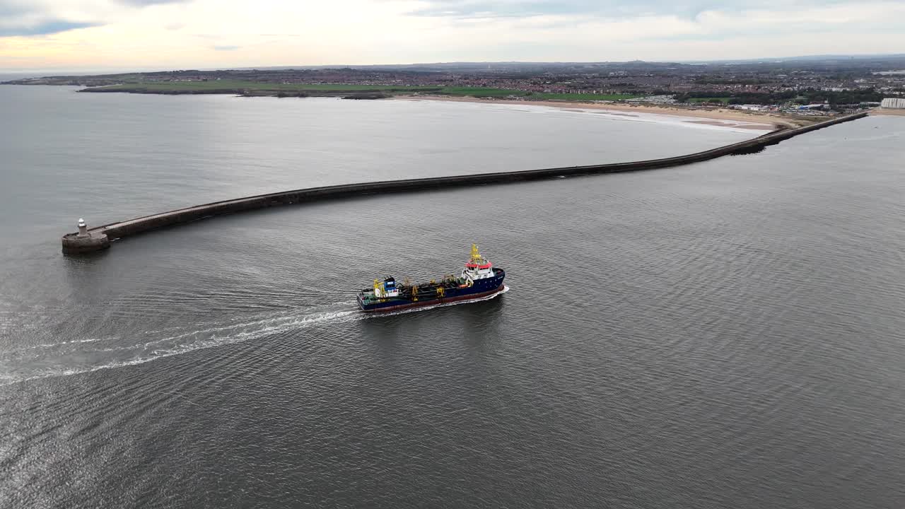 Aerial drone view cargo oil tanker ship shipping global trade economy pulling into harbour port north shields england north east uk