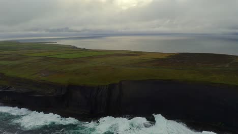 aerial dynamic shot follows the dramatic cliffs on the northern loop head peninsula, county clare