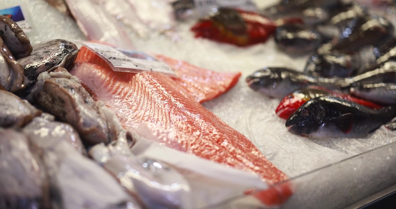 Fresh Salmon Fillet and Seafood on Ice at a Market