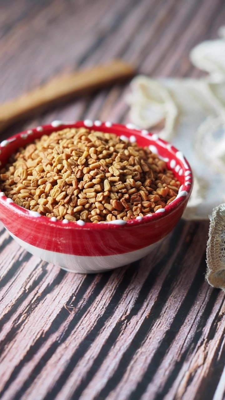 Bowl of Fenugreek Seeds on a Wooden Table