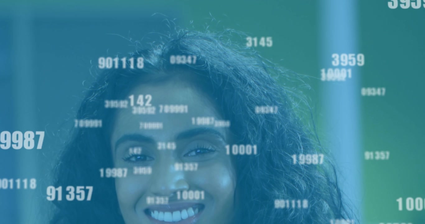 Animation of changing numbers over close up of smiling diverse female standing in office