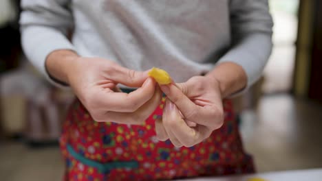 crop woman with tasty tortellini at home