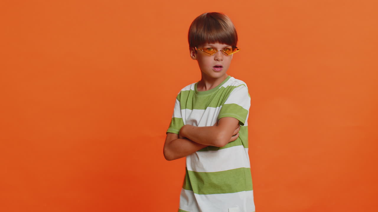 Portrait of confident stylish young preteen child boy kid wearing sunglasses charming smile