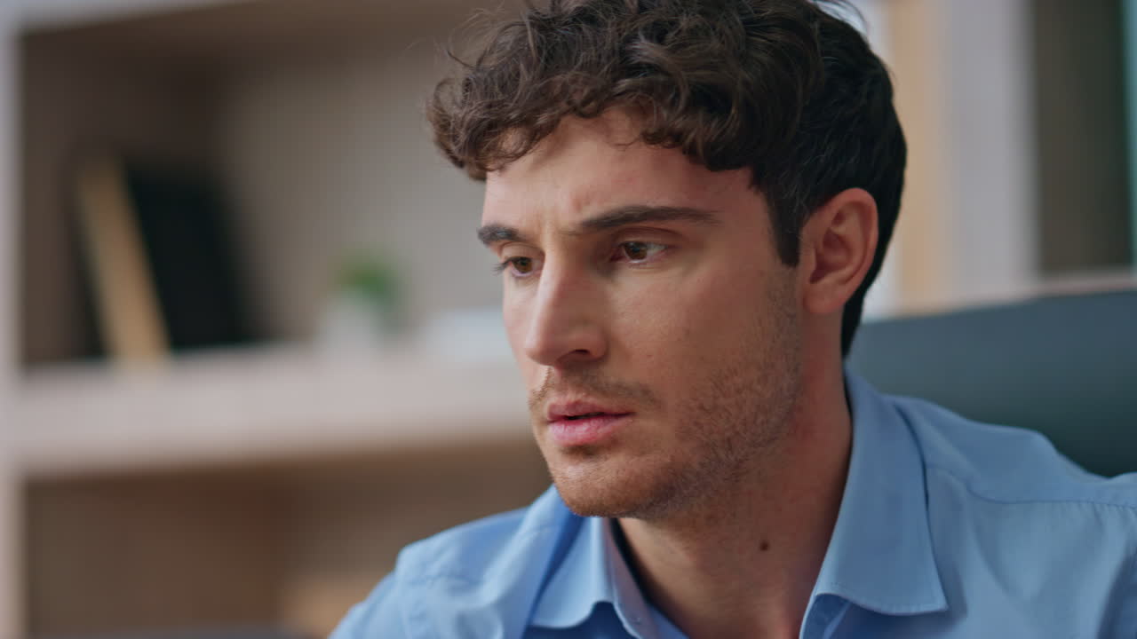 Worried manager reading news at workspace. Closeup frustrated businessman face