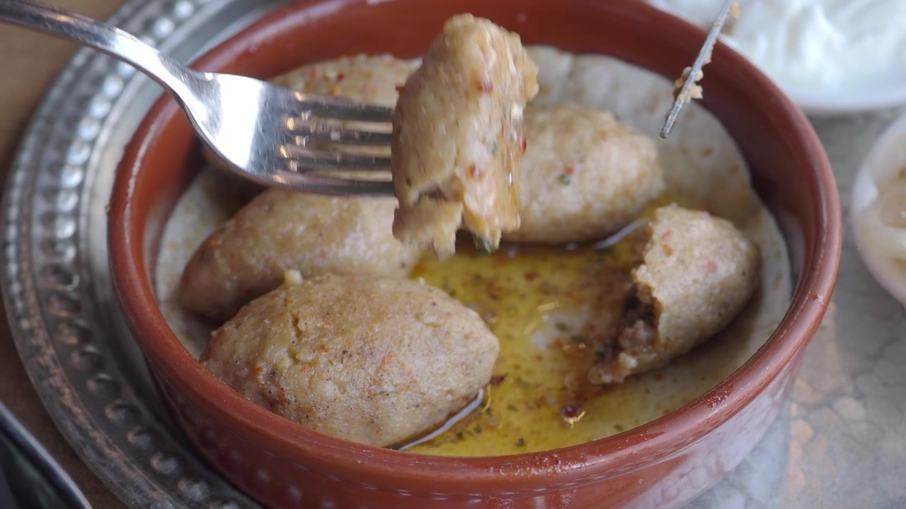 Cutting and Eating Traditional Kibbeh in a Restaurant