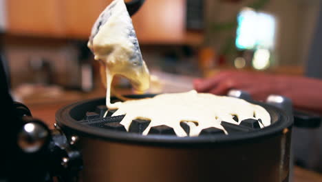 adding more batter to the waffle iron for a delicious breakfast - slow motion isolated