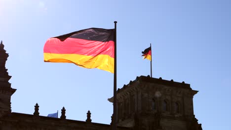 german flag flying on reichstag building germany