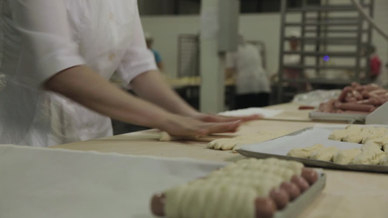 Bakery worker preparing dough for pastries