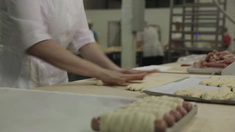 bakery worker preparing dough for pastries