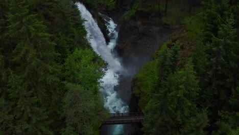 aerial view of powerful cascading alpine waterfalls of riva in the dolomites