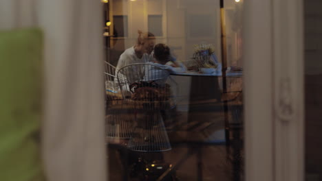 Family-at-home-Window-reflection-at-night