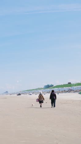 two women walking on a beach