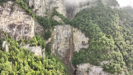 seerenbach falls flowing down steep rocky cliffs in amden betlis, switzerland
