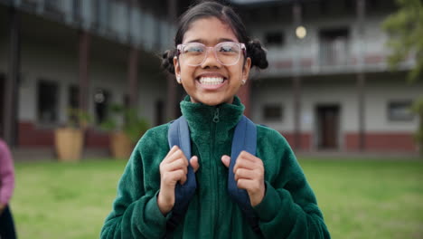 smiling student with backpack in schoolyard