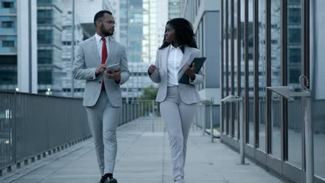 front view of managers walking on street and talking