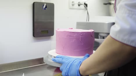 spreading the purple top layer of whipped cream evenly on delicious cake.