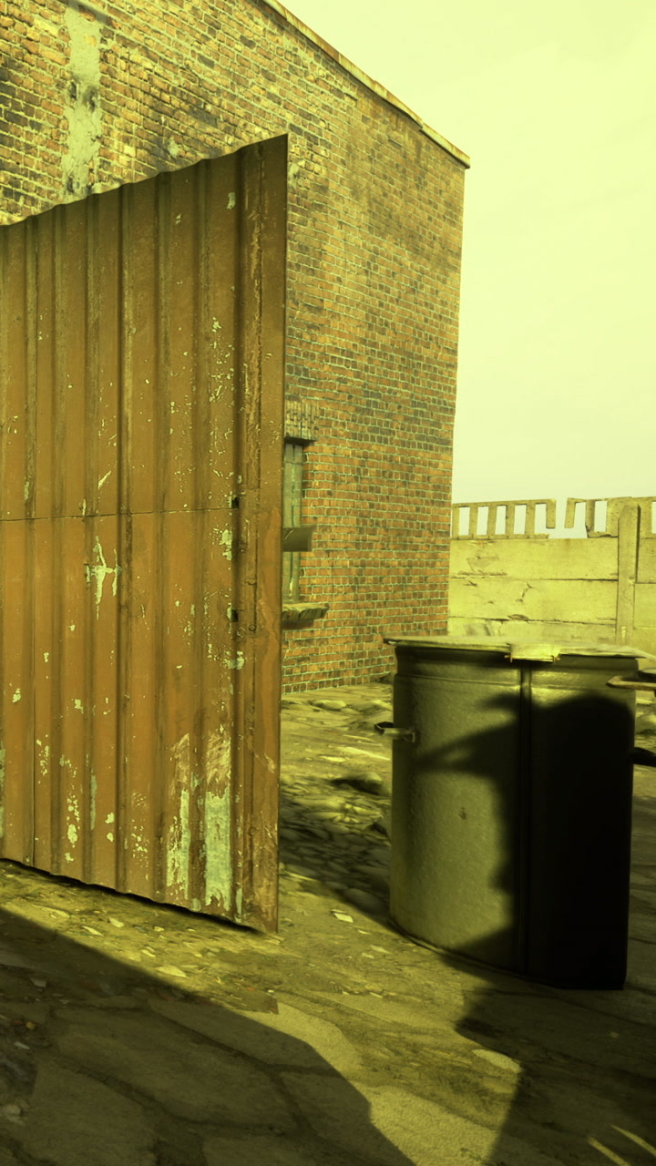 Metal gate opens to a rooftop view over a brick building in the day