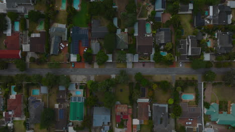 Rocket-footage-of-family-houses-in-residential-neighbourhood.-Top-down-ascending-shot-of-luxury-houses-with-swimming-pools-and-solar-cells.-Port-Elisabeth,-South-Africa