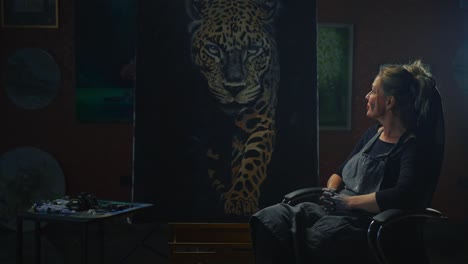 artist in studio with leopard painting