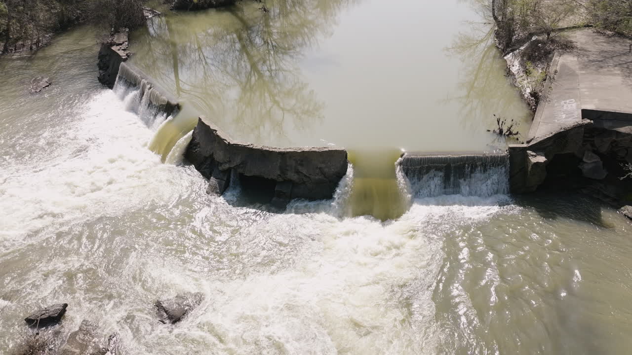 Slow motion shot of a small concrete dam at the West Fork White River Pump Station