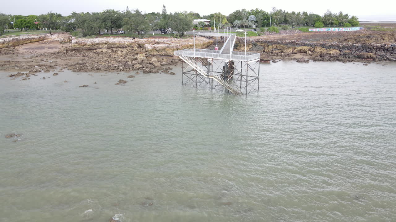 Low moving drone shot of NightCliff Pier in Darwin, Northern Territory