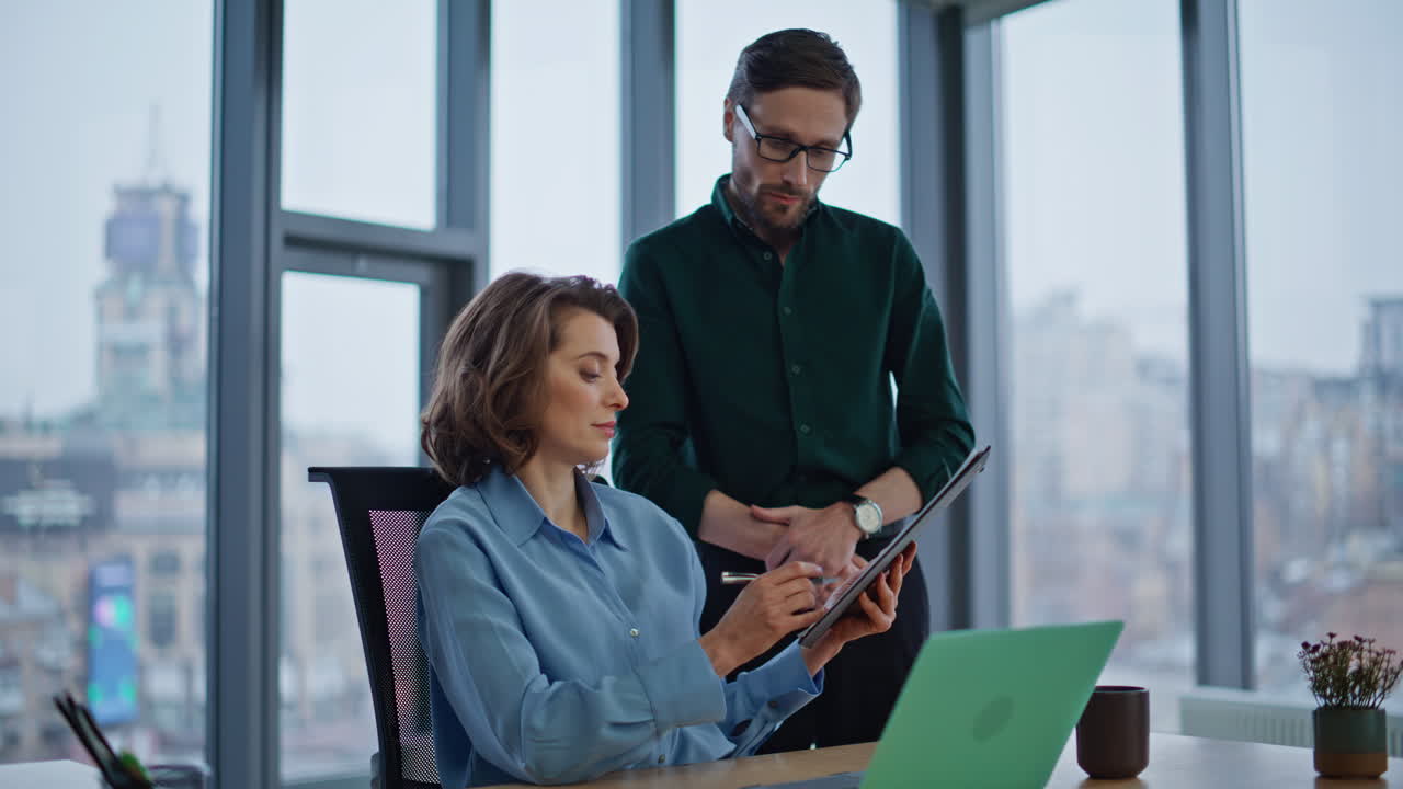 Assistant bringing documents businesswoman working at laptop in office closeup